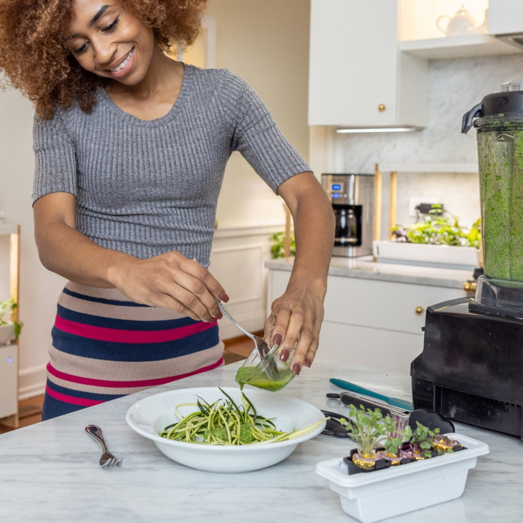 Harvesting fresh greens from a Personal Rise Garden